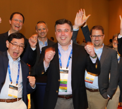 Group of ANA members cheering and celebrating together.