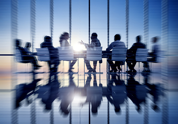 abstract picture of group of people sitting in a board room